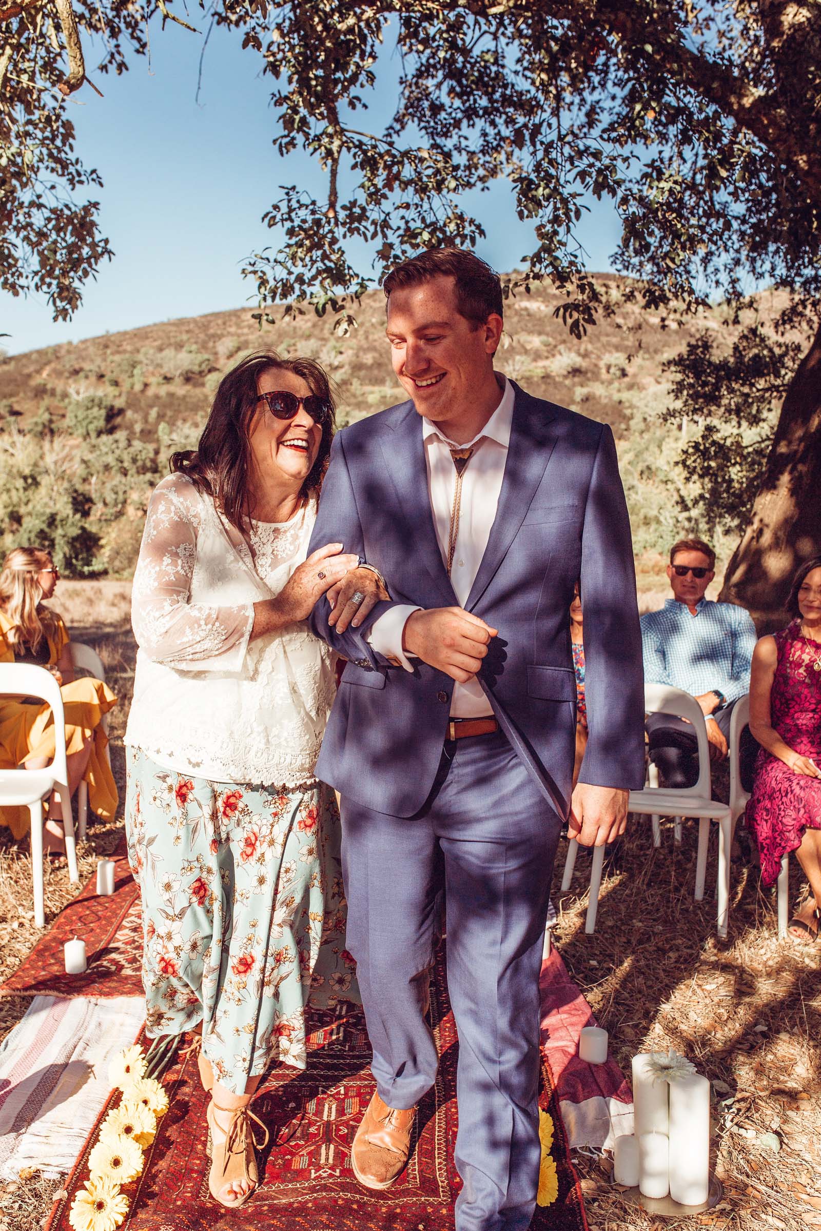 Mother walks son down aisle under cork trees at wedding Herdade da Matinha portugal