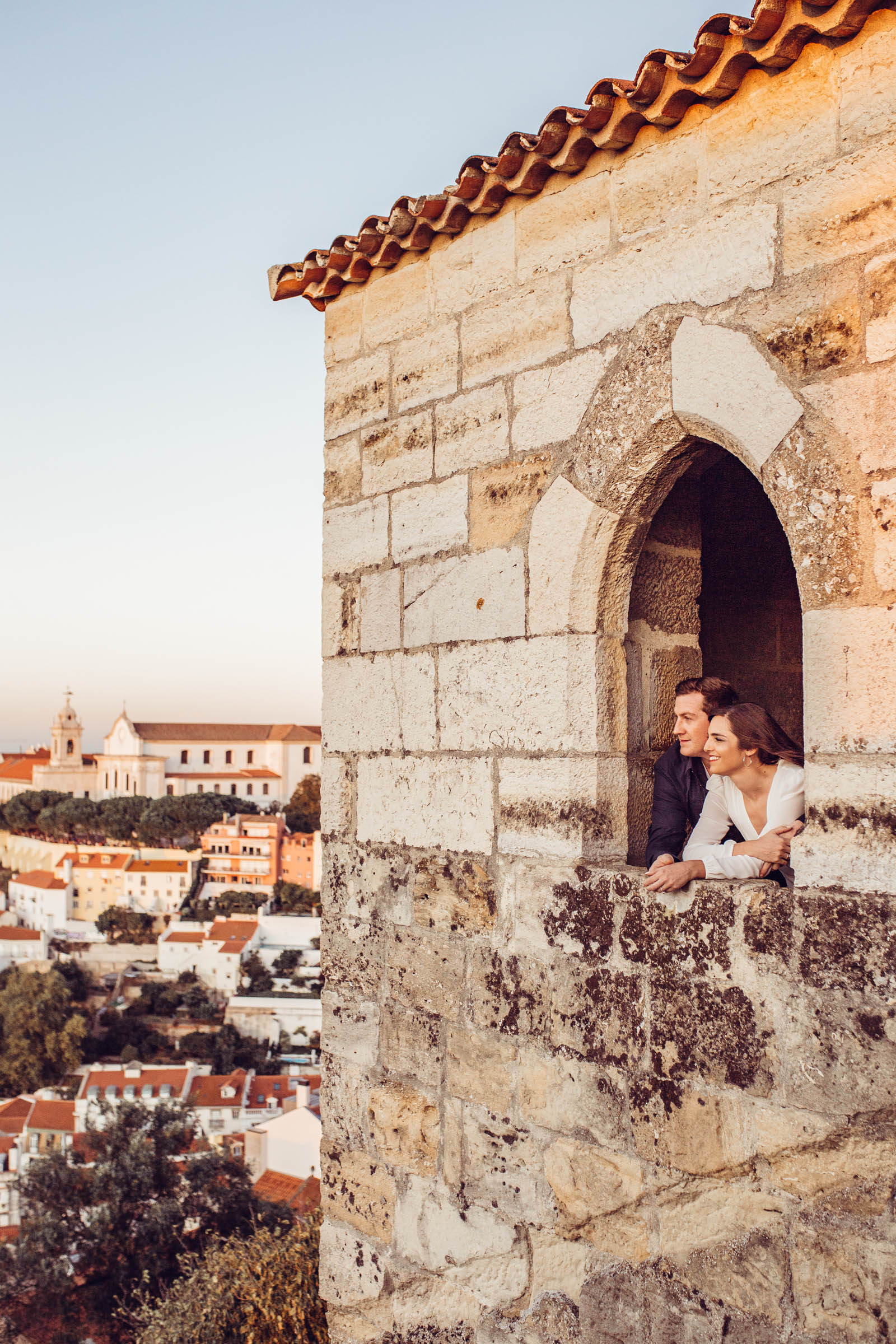 Couple stares out castle window in Lisbon Portugal