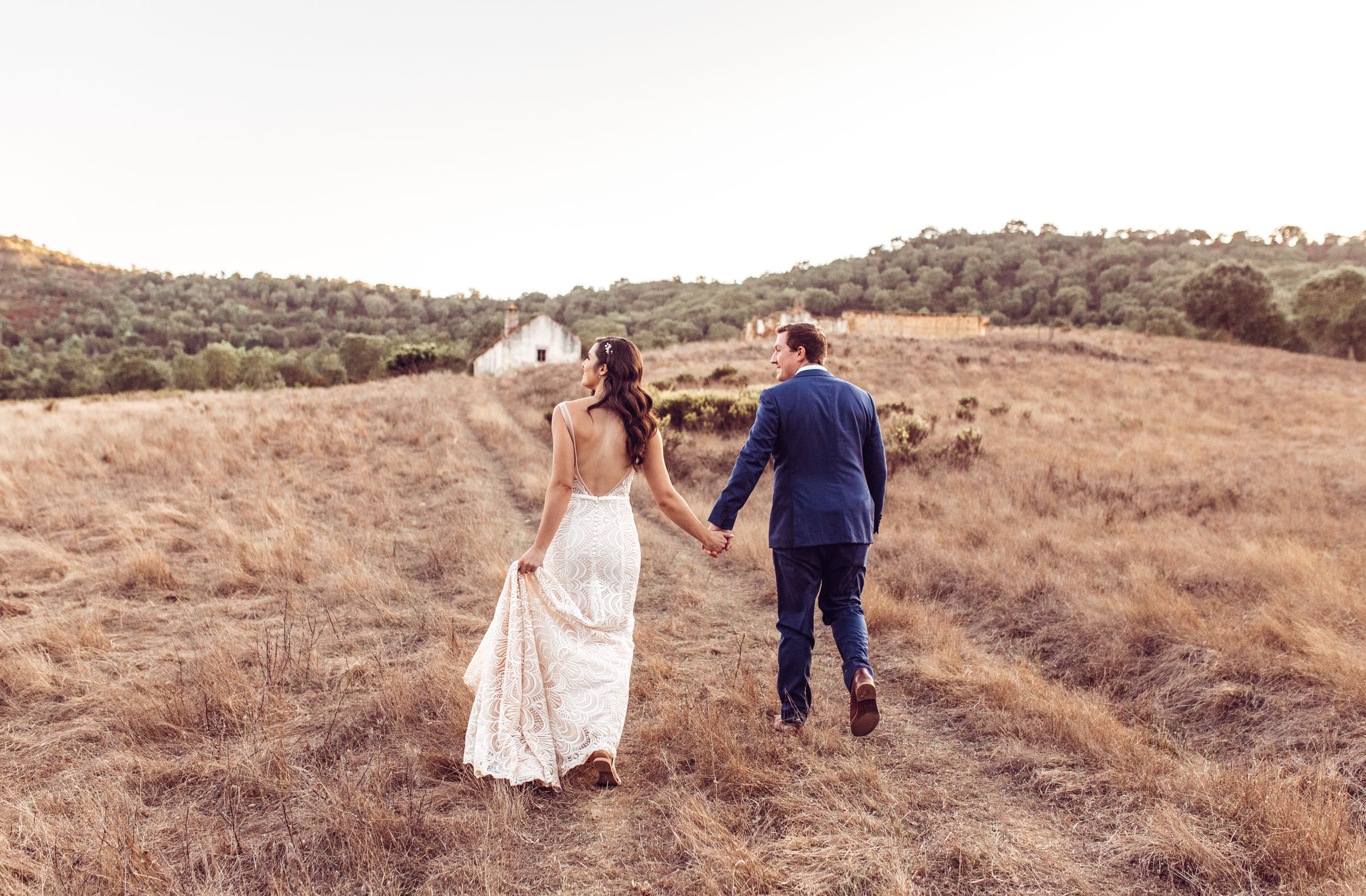 Bride and groom during golden hour at field near Herdade da Matinha portugal