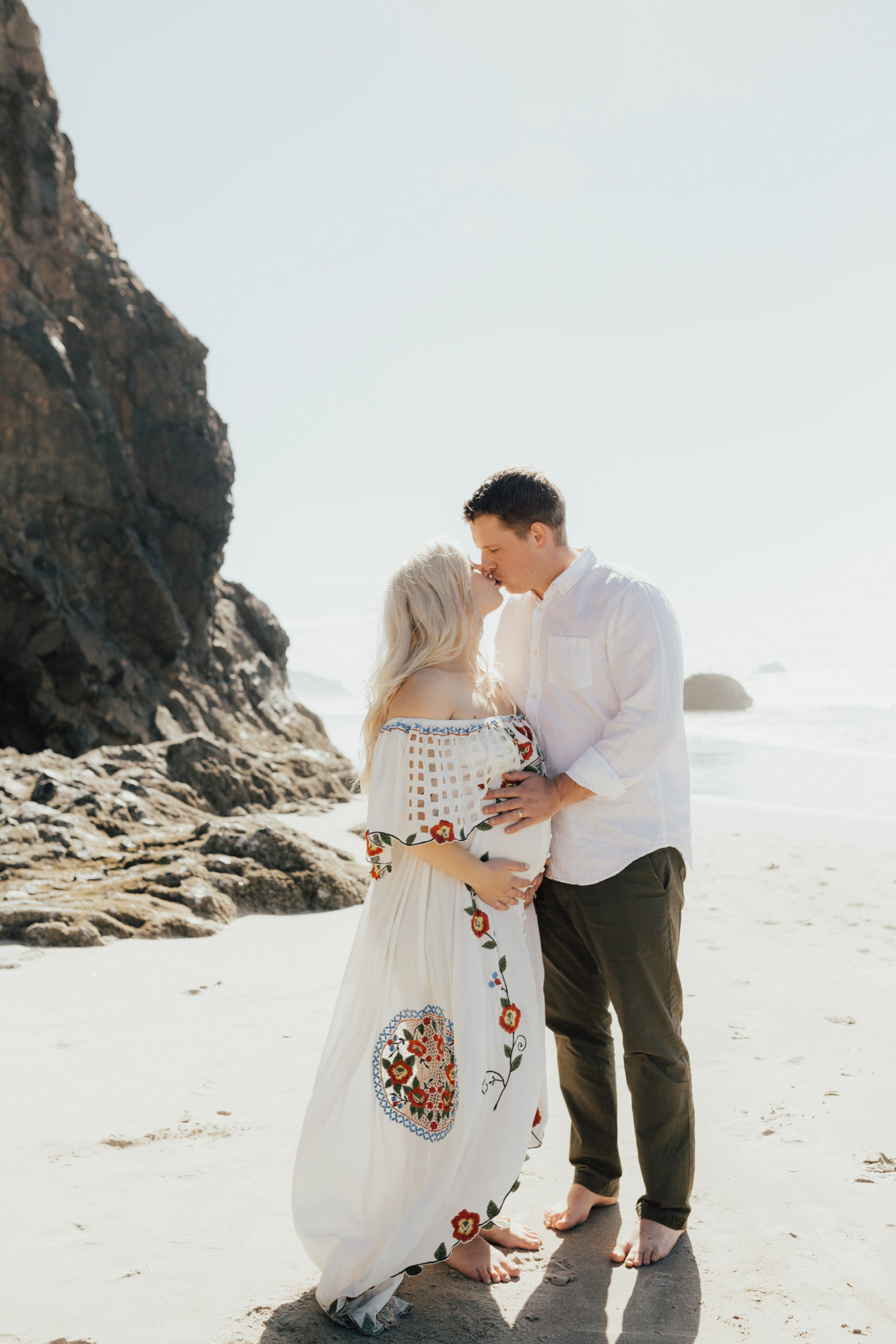 Maternity image of couple kissing at Hug Point beach photography