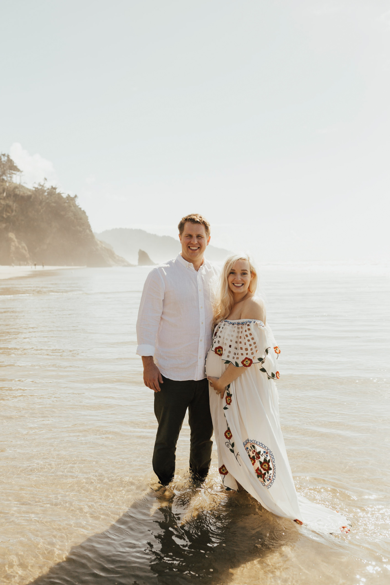 Maternity image of couple in ocean at Hug Point beach photography