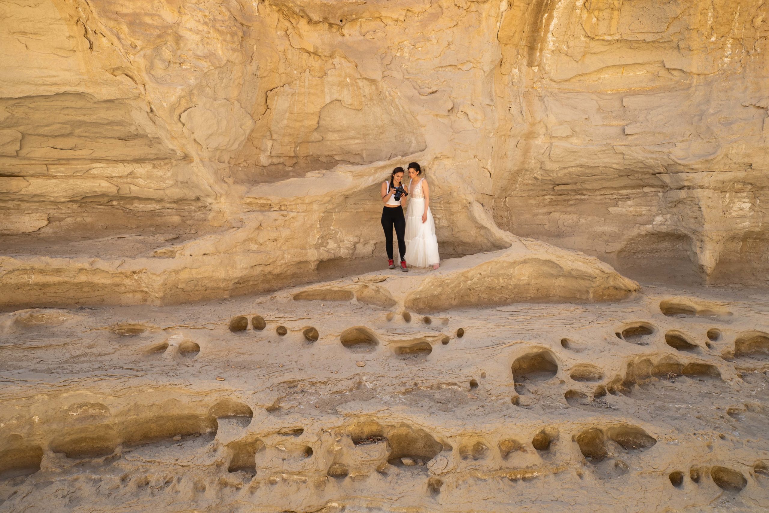 Bailey O'Bar photographs a woman wearing a wedding dress for an elopement in the landscapes of Utah