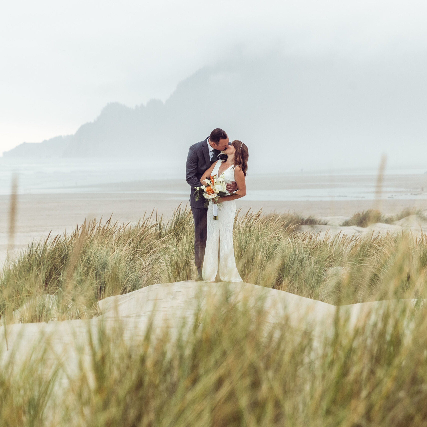 Wedding photography of a couple on the beach in sand dunes at Manzanita on the Oregon Coast